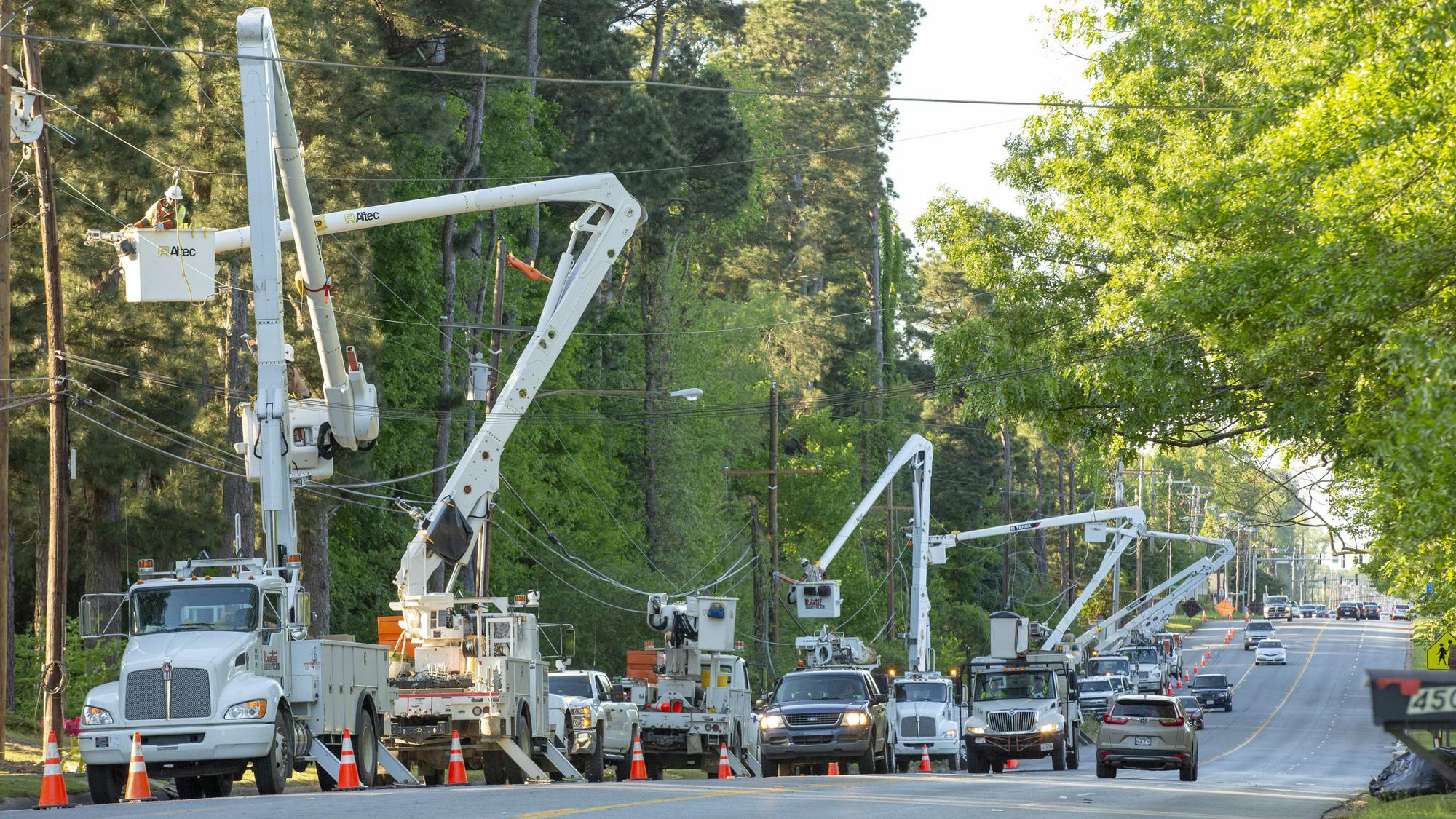 Workers tackle a line of broken poles in Pine Bluff Monday.